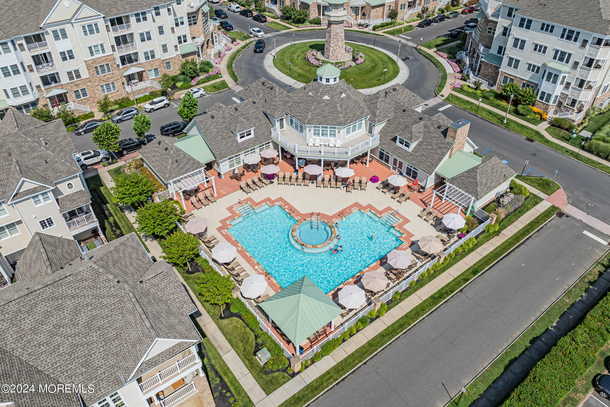 33 Cooper Avenue, Unit 215 Long Branch, NJ 07740 - Photo 4 of 27 an aerial view of a pool patio chairs and fire pit