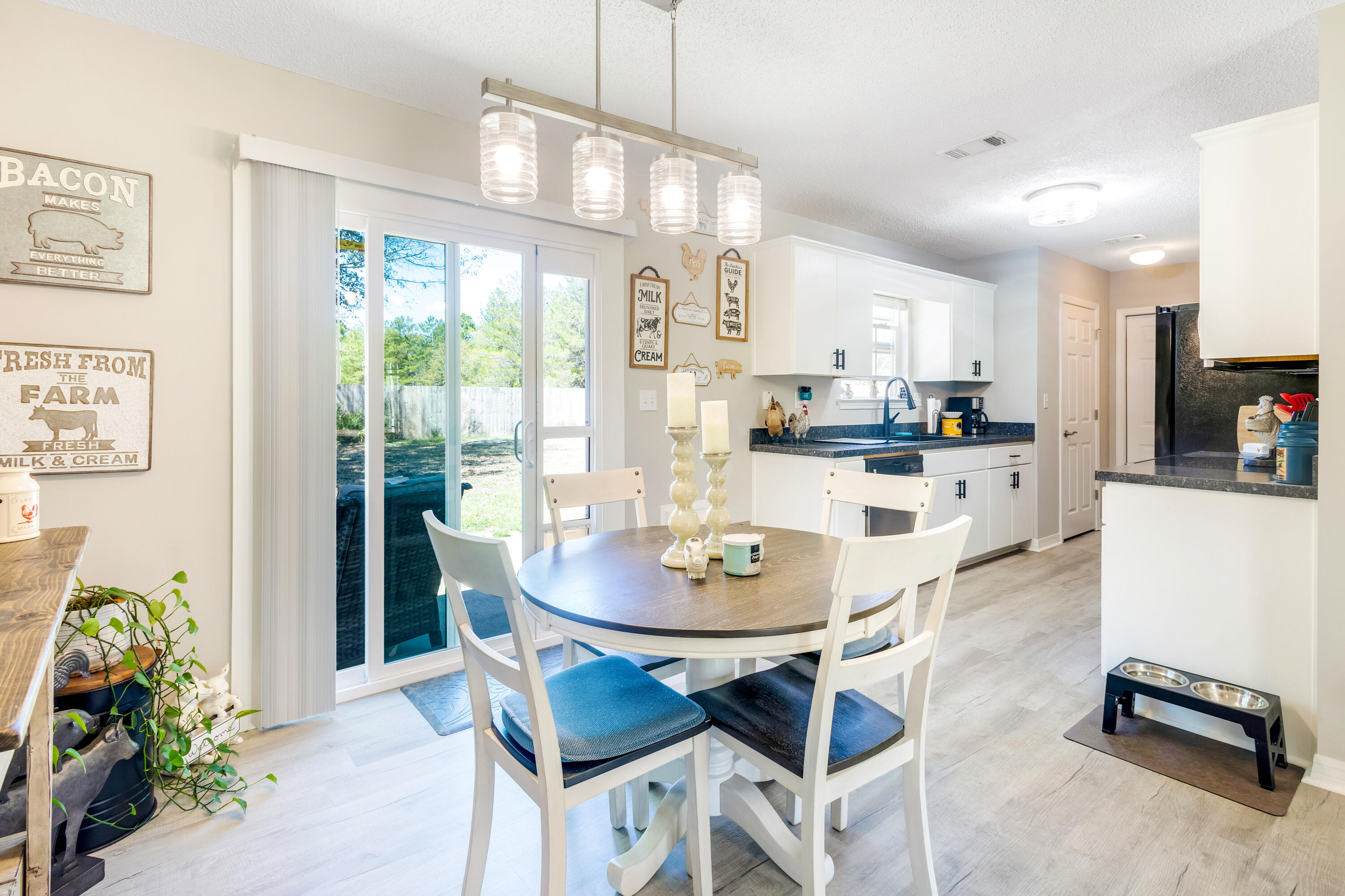 103 Valley View Drive DeFuniak Springs, FL 32433 - Photo 12 of 34 a kitchen with stainless steel appliances kitchen island granite countertop a dining table and chairs