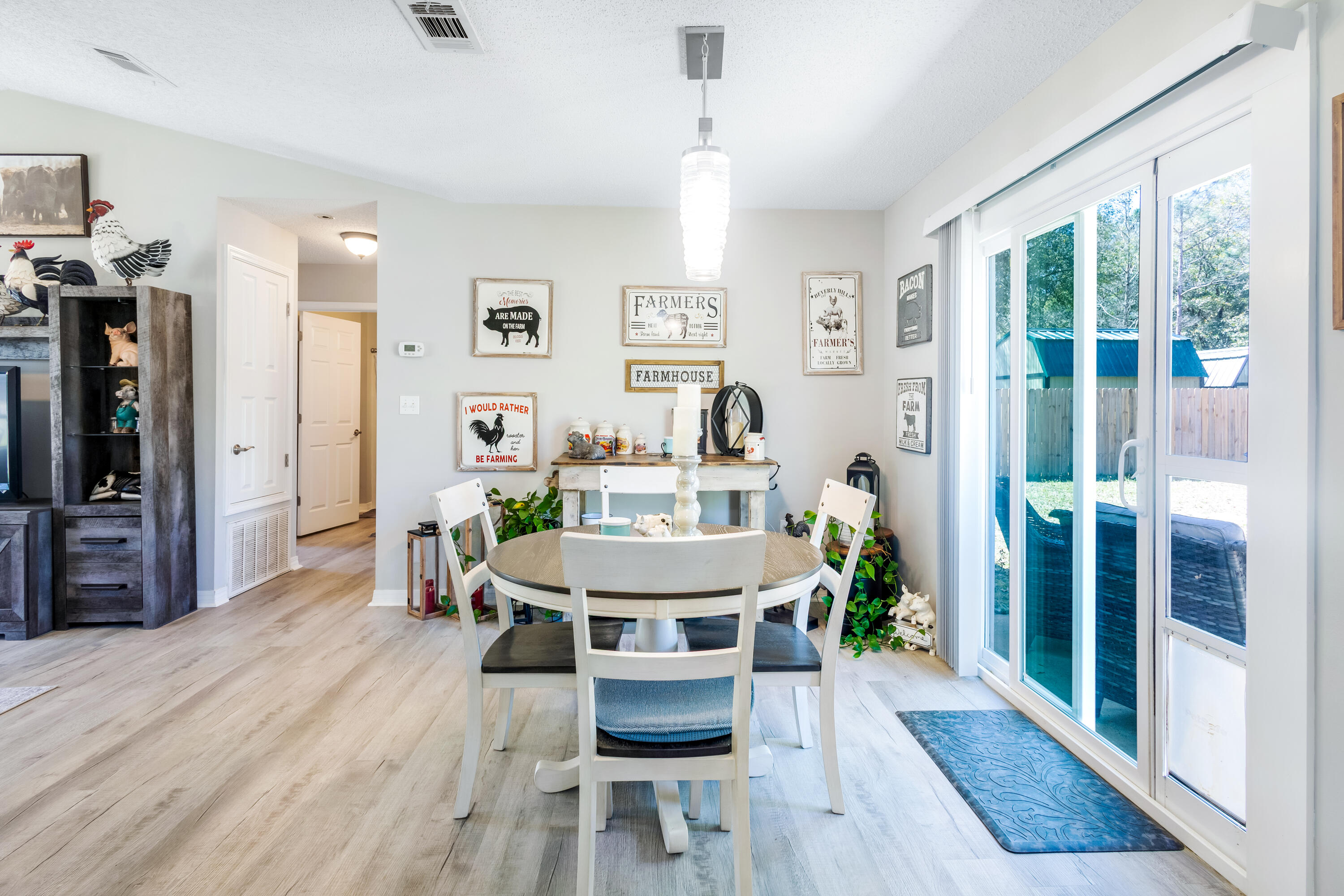 103 Valley View Drive DeFuniak Springs, FL 32433 - Photo 13 of 34 a living room with furniture a large window wooden floor and a rug