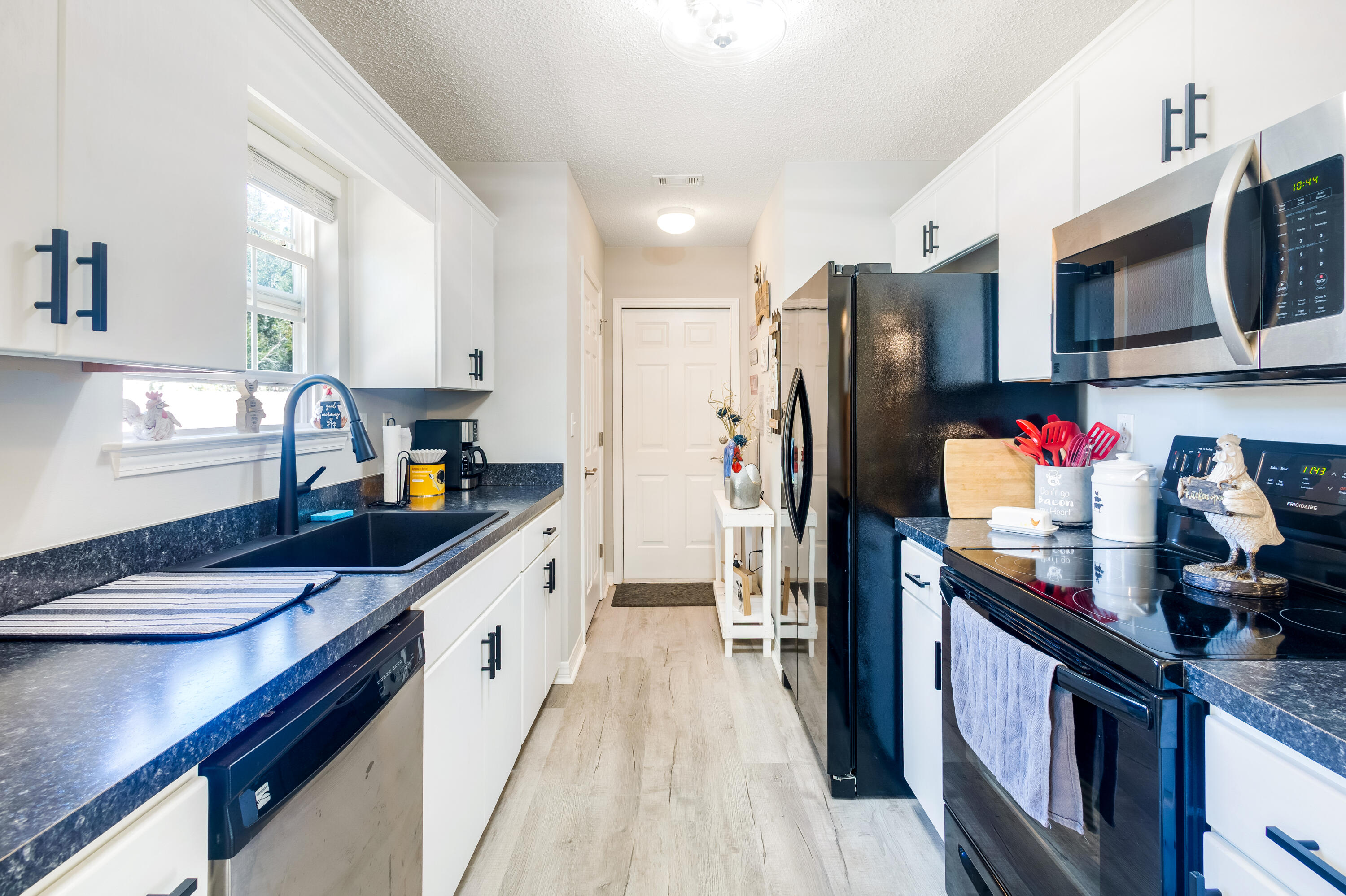 103 Valley View Drive DeFuniak Springs, FL 32433 - Photo 14 of 34 a kitchen with stainless steel appliances granite countertop a sink stove and refrigerator