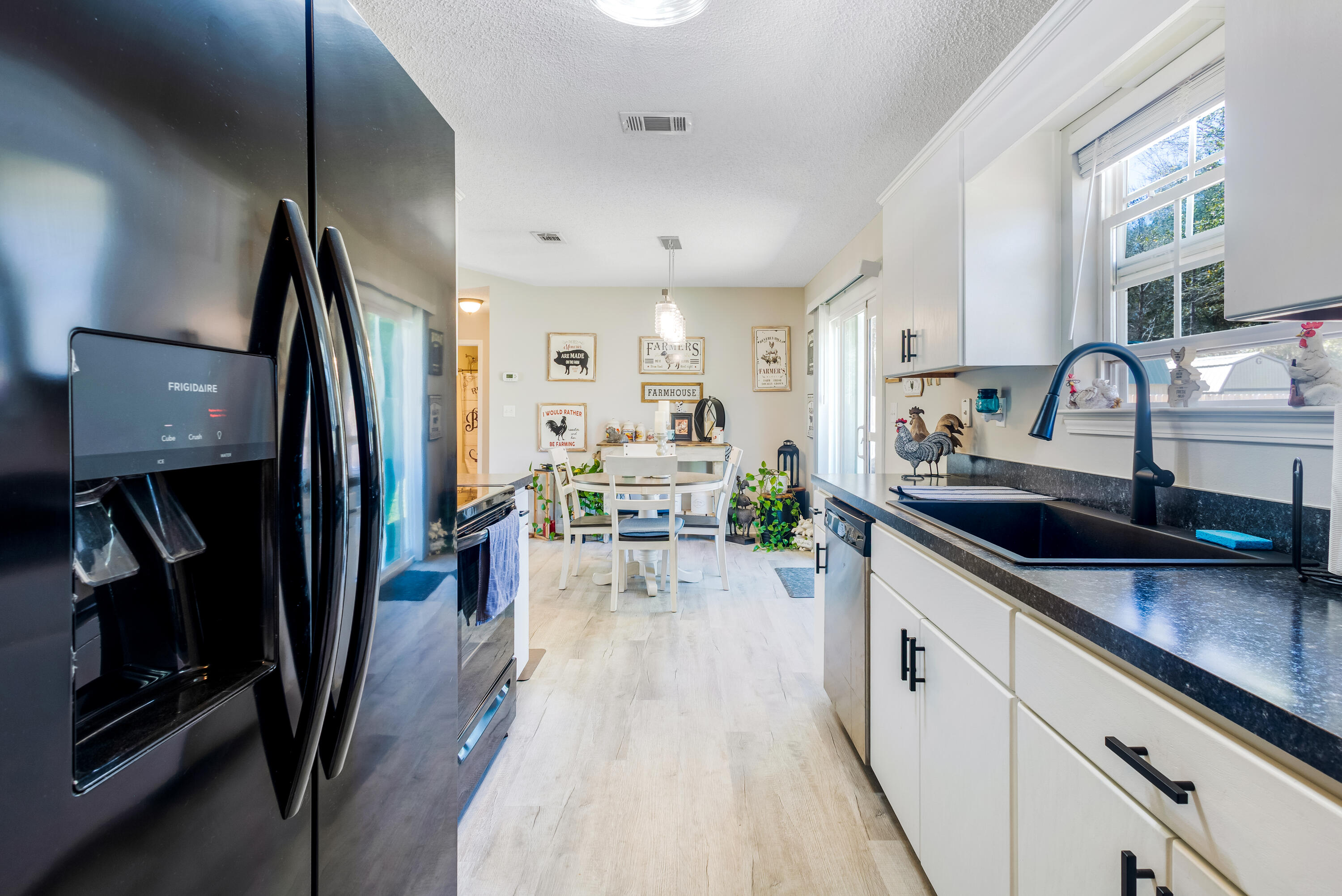 103 Valley View Drive DeFuniak Springs, FL 32433 - Photo 17 of 34 a kitchen with sink refrigerator and microwave