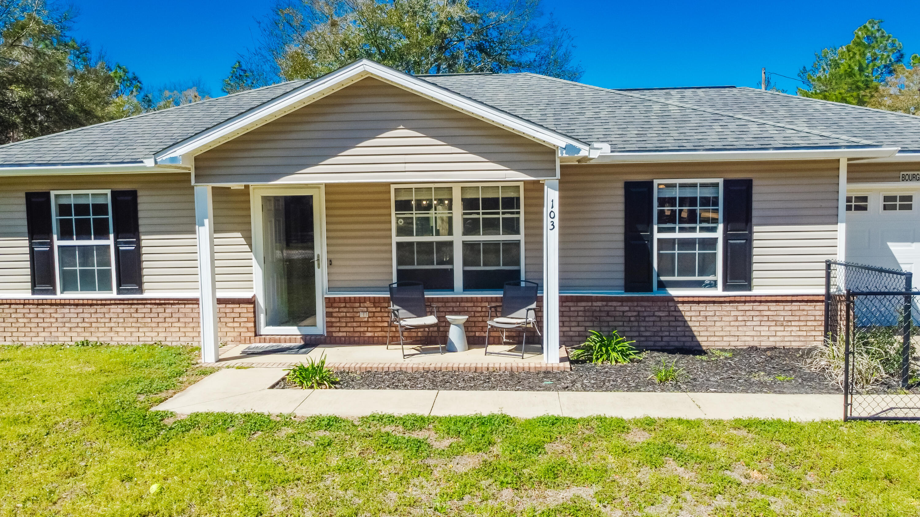 103 Valley View Drive DeFuniak Springs, FL 32433 - Photo 2 of 34 a front view of a house with a yard and porch