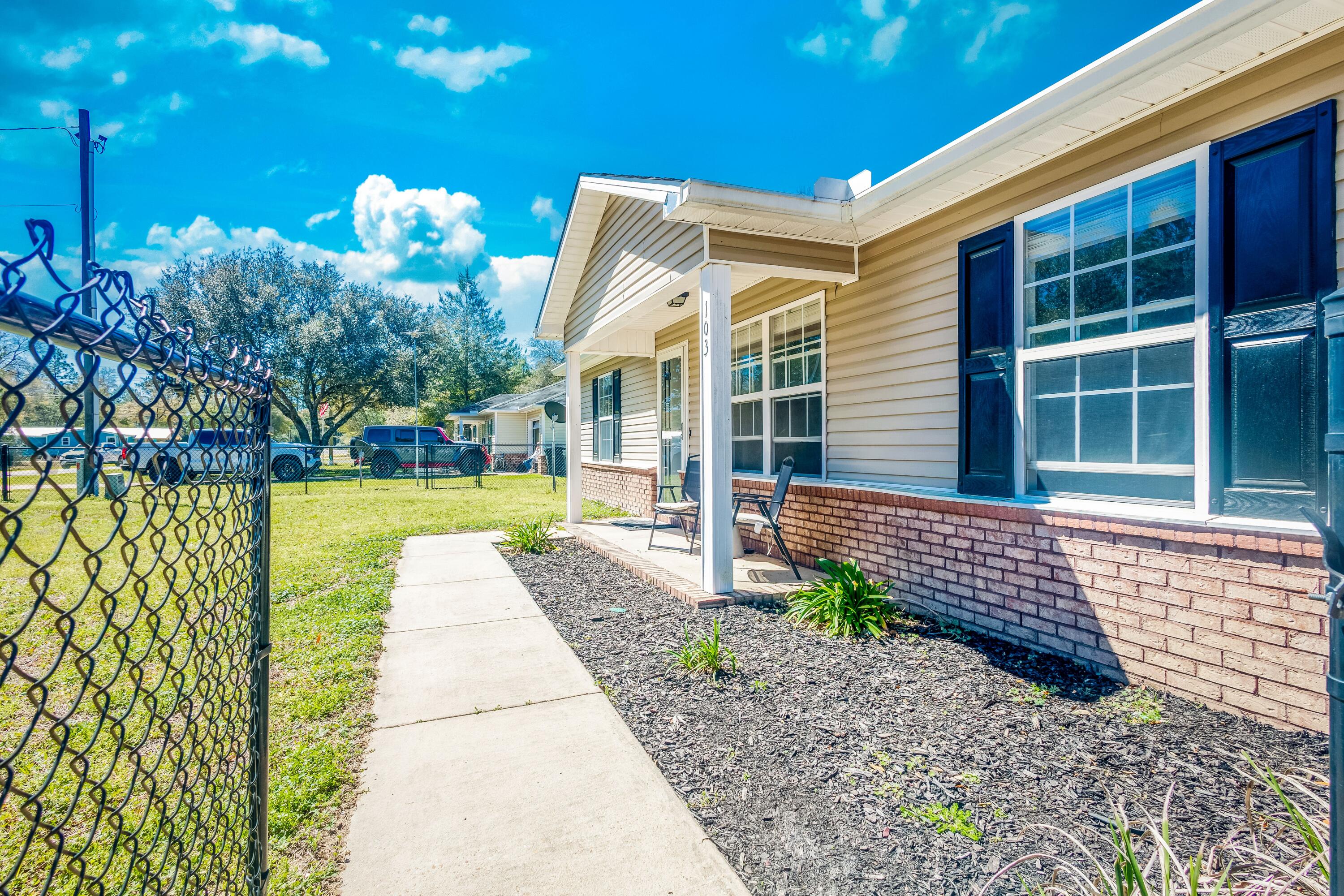 103 Valley View Drive DeFuniak Springs, FL 32433 - Photo 3 of 34 a front view of a house with garden