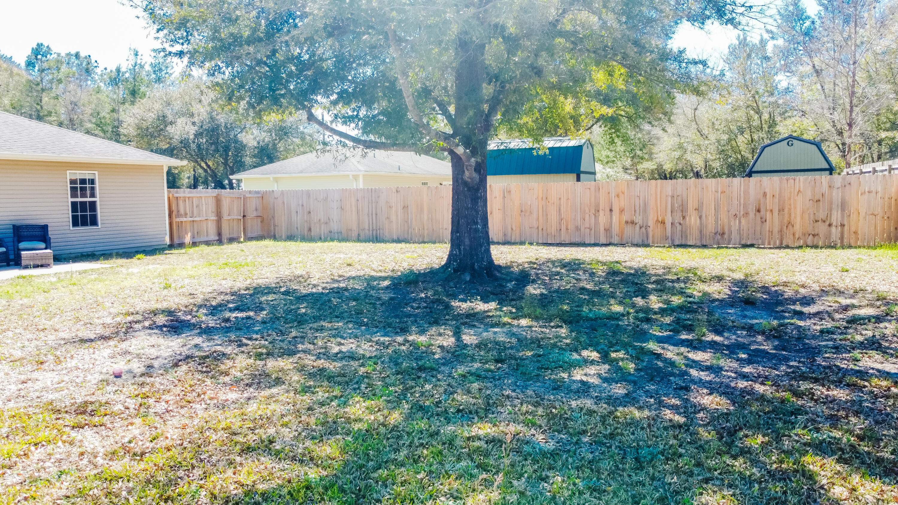 103 Valley View Drive DeFuniak Springs, FL 32433 - Photo 34 of 34 a view of backyard with wooden fence and large trees