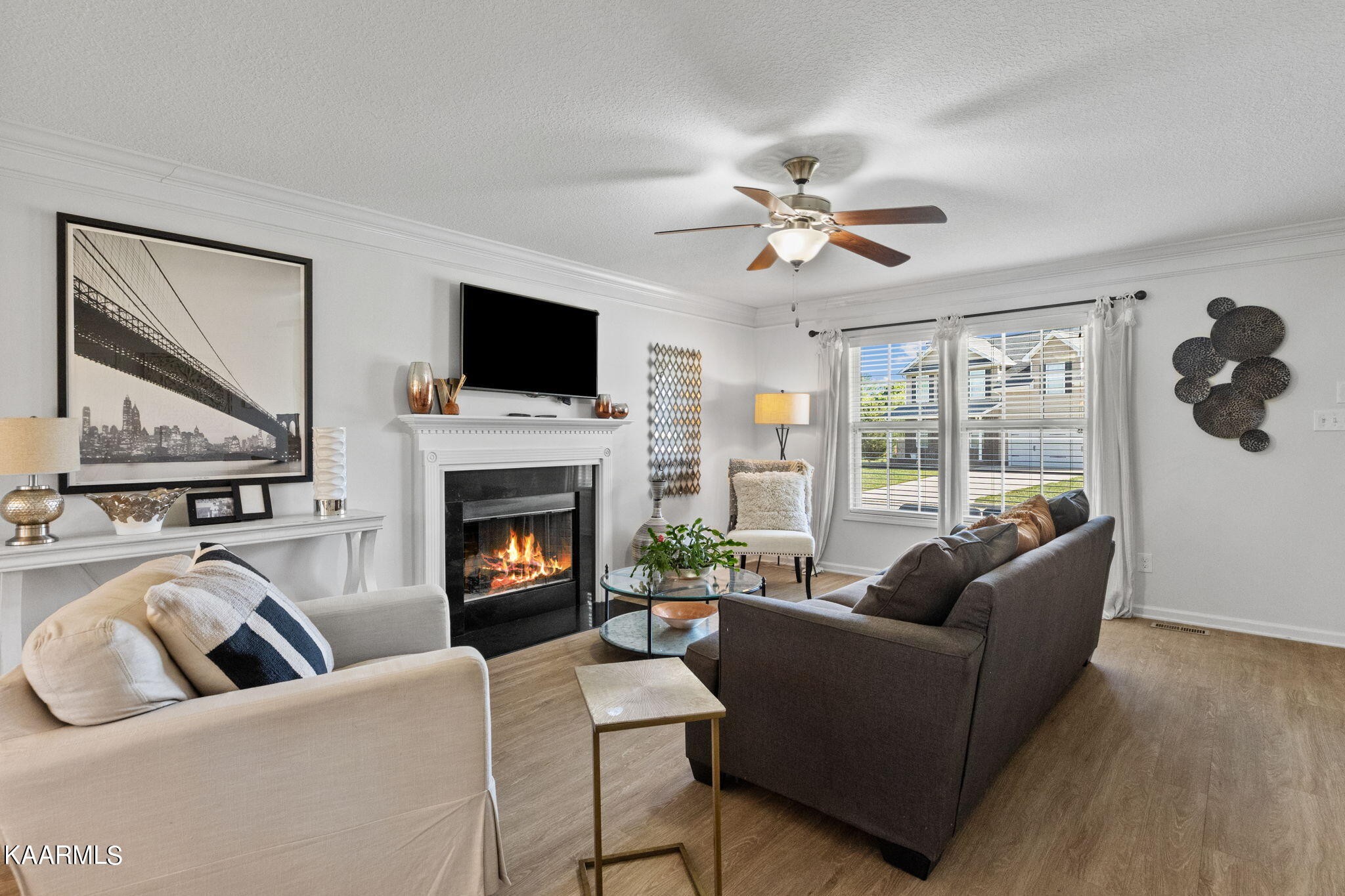 1825 Turning Point Road Powell, TN 37849 - Photo 12 of 40 a living room with furniture a flat screen tv and a fireplace