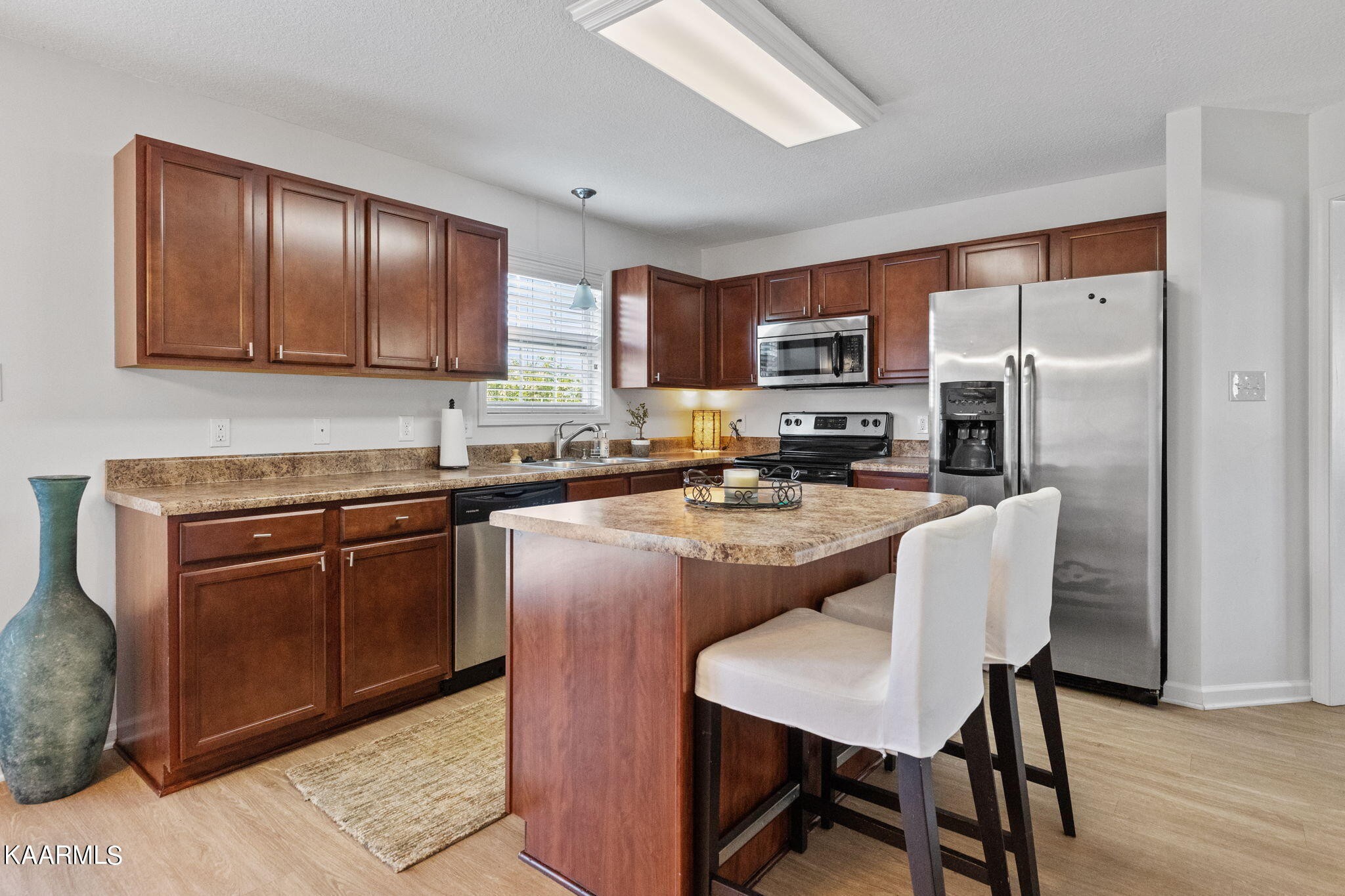 1825 Turning Point Road Powell, TN 37849 - Photo 18 of 40 a kitchen with stainless steel appliances granite countertop a stove refrigerator sink and cabinets