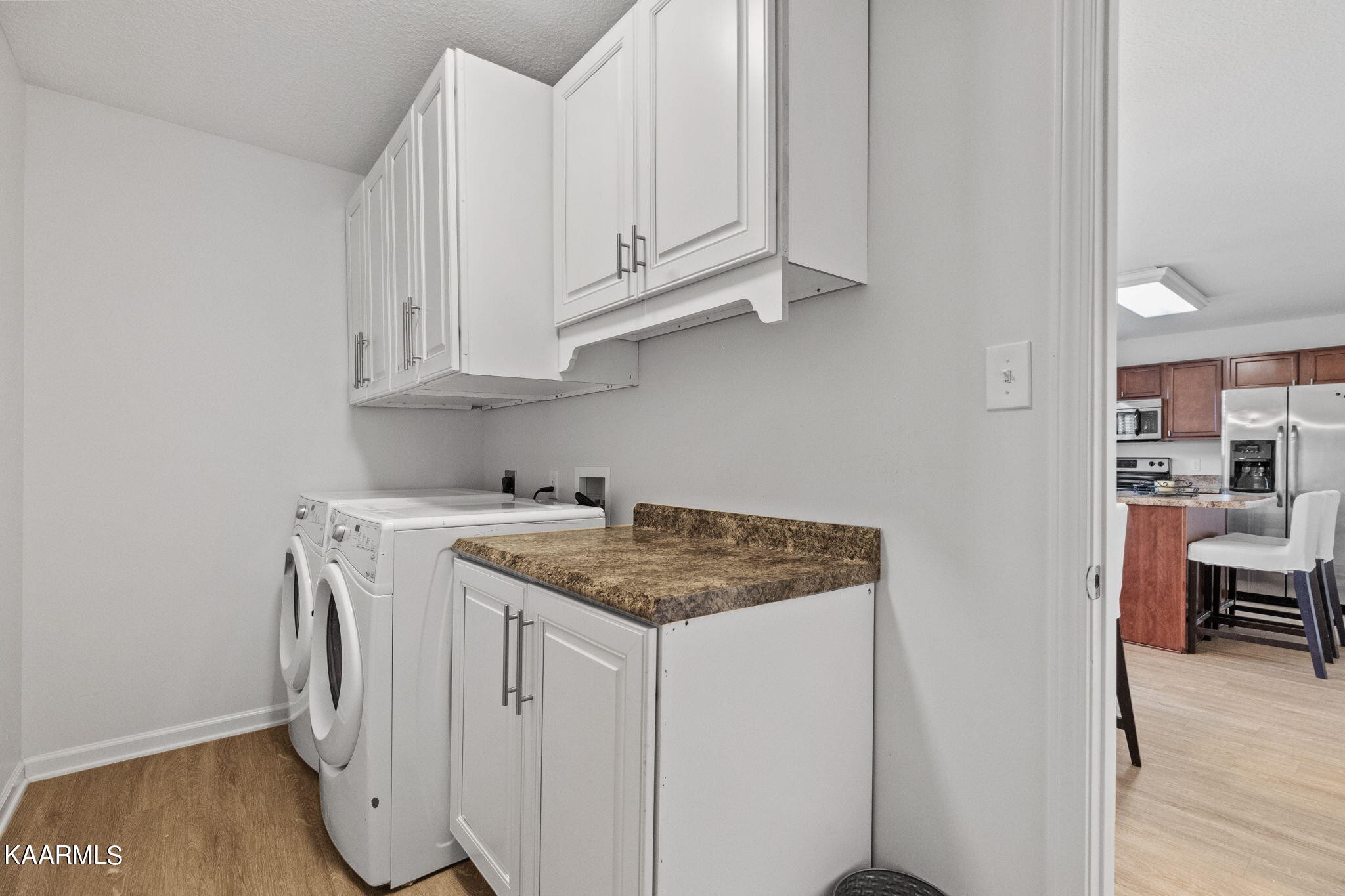 1825 Turning Point Road Powell, TN 37849 - Photo 22 of 40 a kitchen with stainless steel appliances granite countertop a sink a stove and dishwasher with wooden floor