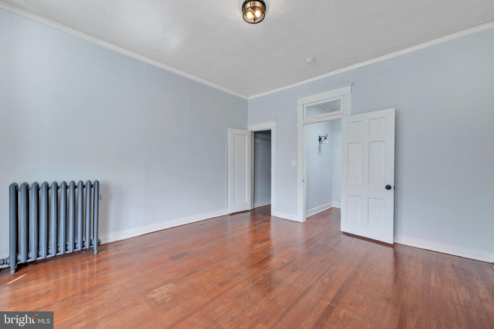 2822 Riggs Avenue Baltimore, MD 21216 - Photo 22 of 30 a view of an empty room with wooden floor
