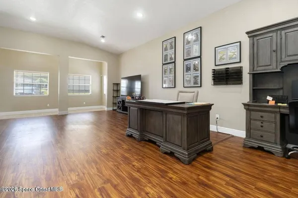 a kitchen with stainless steel appliances granite countertop a stove a sink and a microwave oven with wooden floor