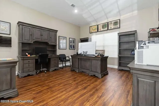 a living room with furniture and a kitchen view