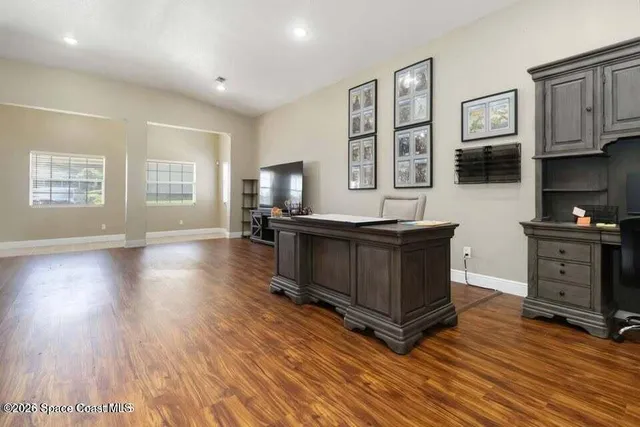 a kitchen with stainless steel appliances granite countertop a stove a sink and a microwave oven with wooden floor