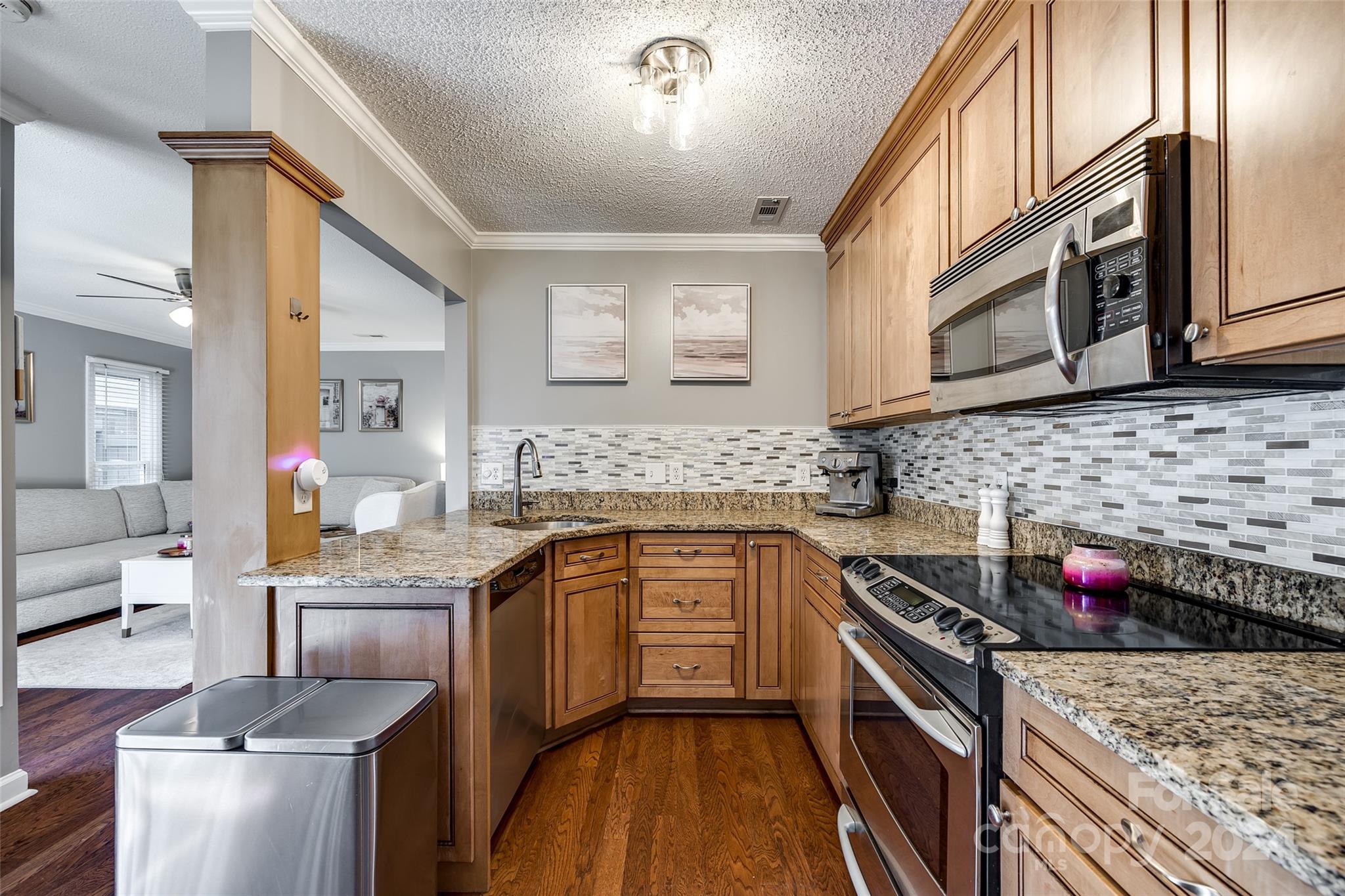 414 West 9th Street, Unit F Charlotte, NC 28202 - Photo 12 of 31 a kitchen with stainless steel appliances granite countertop a sink stove and cabinets