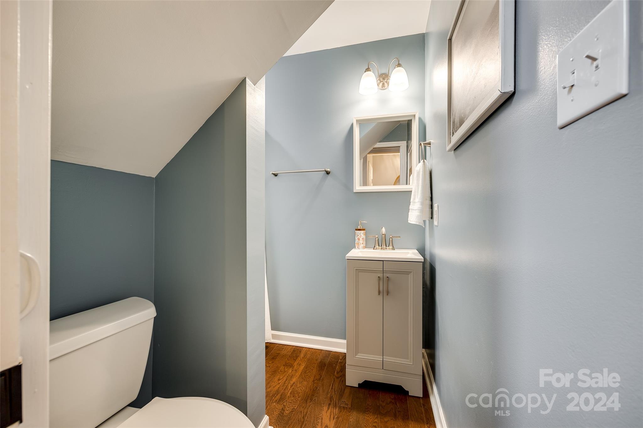 414 West 9th Street, Unit F Charlotte, NC 28202 - Photo 14 of 31 a bathroom with a sink a toilet and mirror