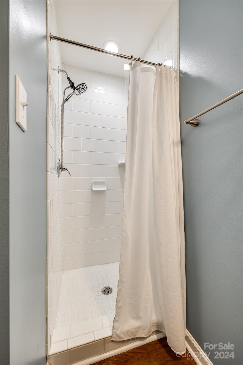414 West 9th Street, Unit F Charlotte, NC 28202 - Photo 15 of 31 a bathroom with a shower and a glass door