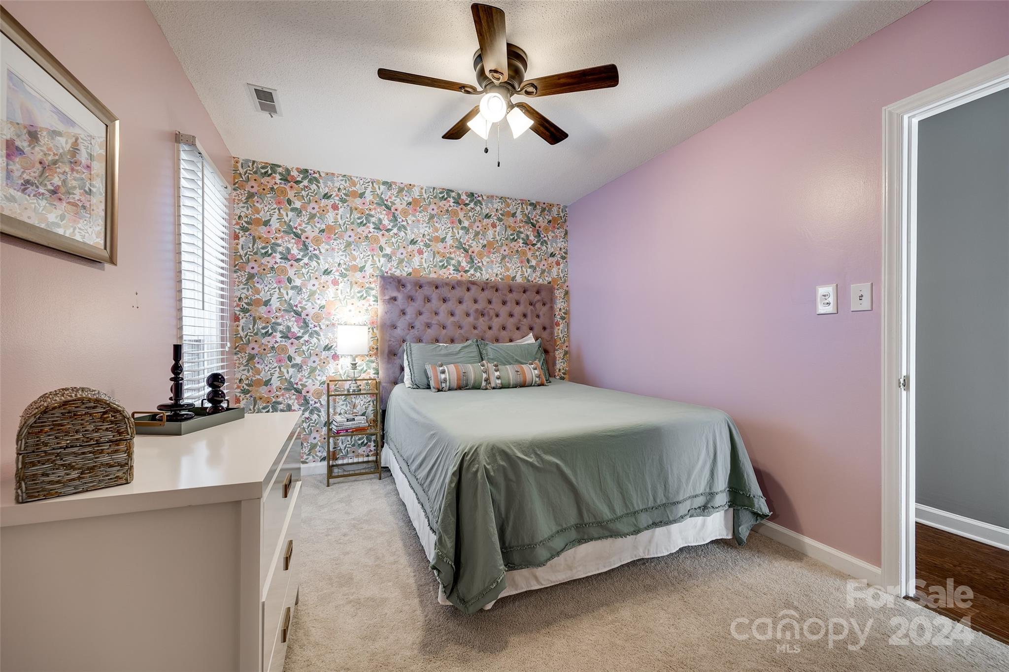 414 West 9th Street, Unit F Charlotte, NC 28202 - Photo 19 of 31 a bedroom with a bed and a chandelier