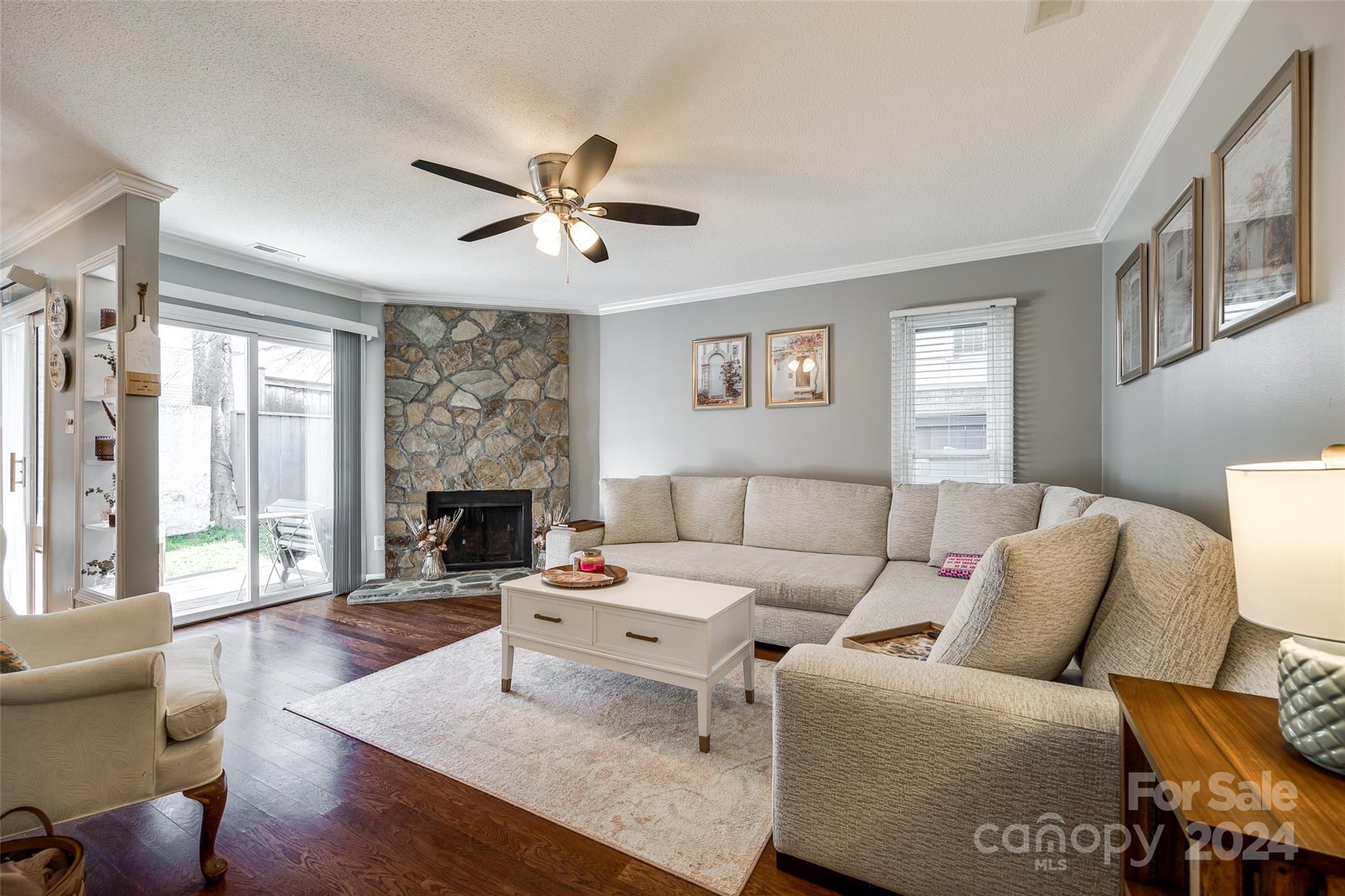 414 West 9th Street, Unit F Charlotte, NC 28202 - Photo 2 of 31 a living room with furniture a fireplace and a large window