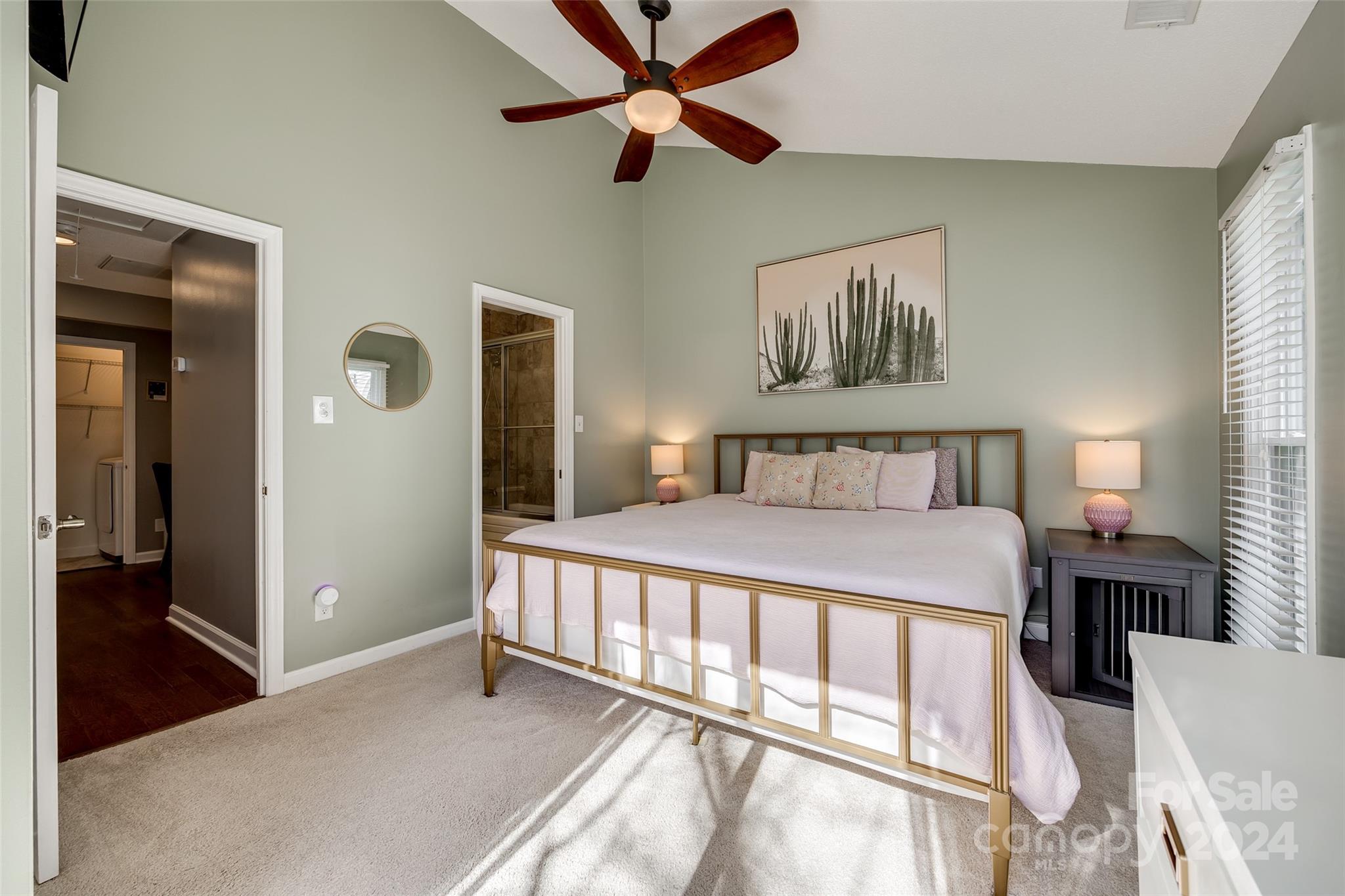 414 West 9th Street, Unit F Charlotte, NC 28202 - Photo 21 of 31 a bedroom with a large bed and a chandelier fan