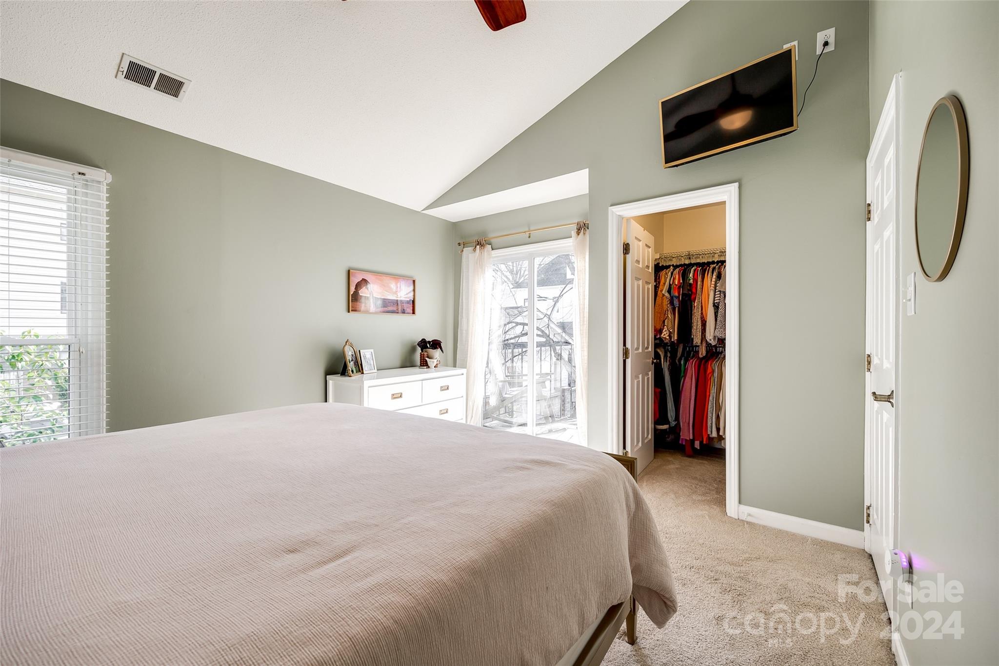 414 West 9th Street, Unit F Charlotte, NC 28202 - Photo 22 of 31 a bedroom with a bed and a flat screen tv
