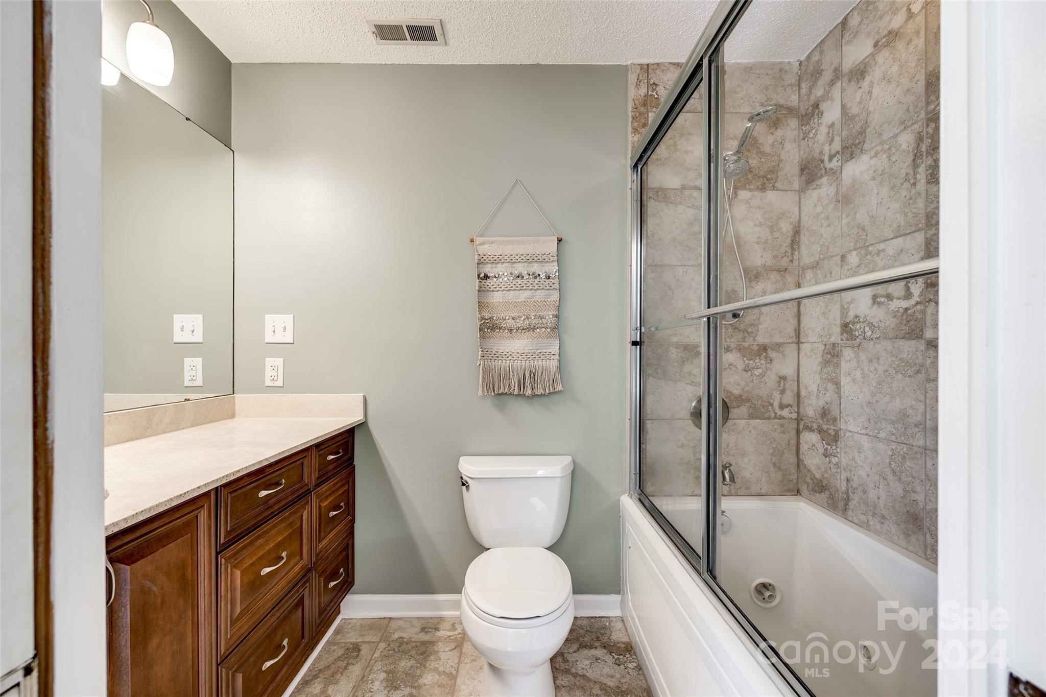 414 West 9th Street, Unit F Charlotte, NC 28202 - Photo 23 of 31 a bathroom with a sink a toilet and shower