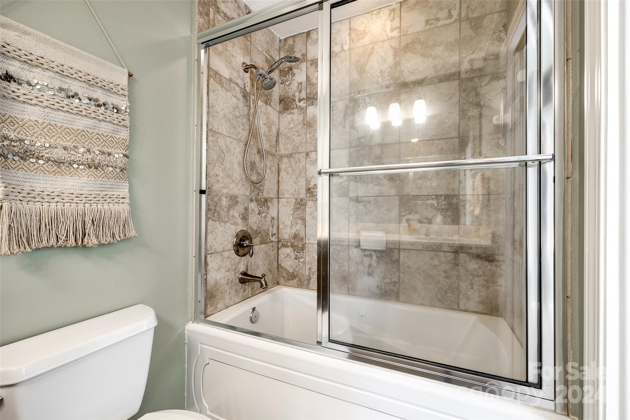414 West 9th Street, Unit F Charlotte, NC 28202 - Photo 25 of 31 a bathroom with a shower and toilet