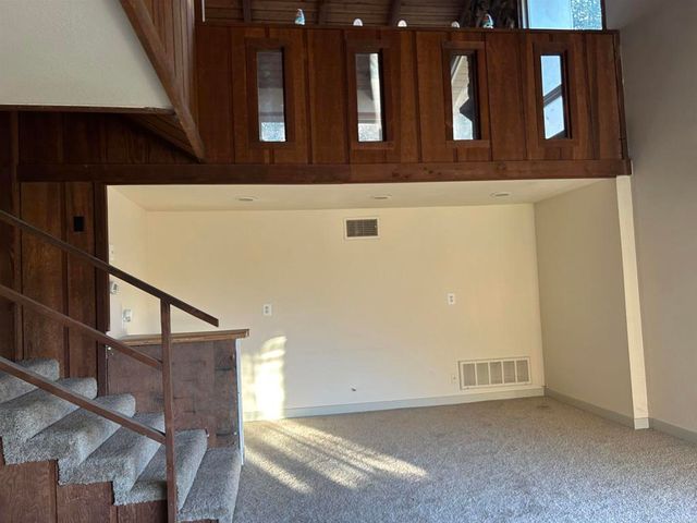 a view of staircase with lots of frames on wall
