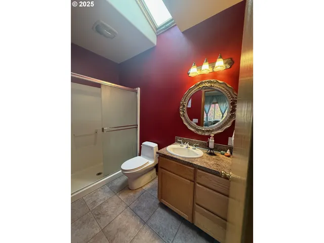 a bathroom with a toilet a sink and a mirror