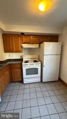 a kitchen with a stove a sink and a refrigerator