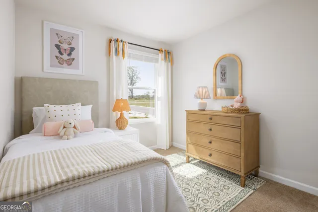 a bedroom with a bed and a painting on the wall