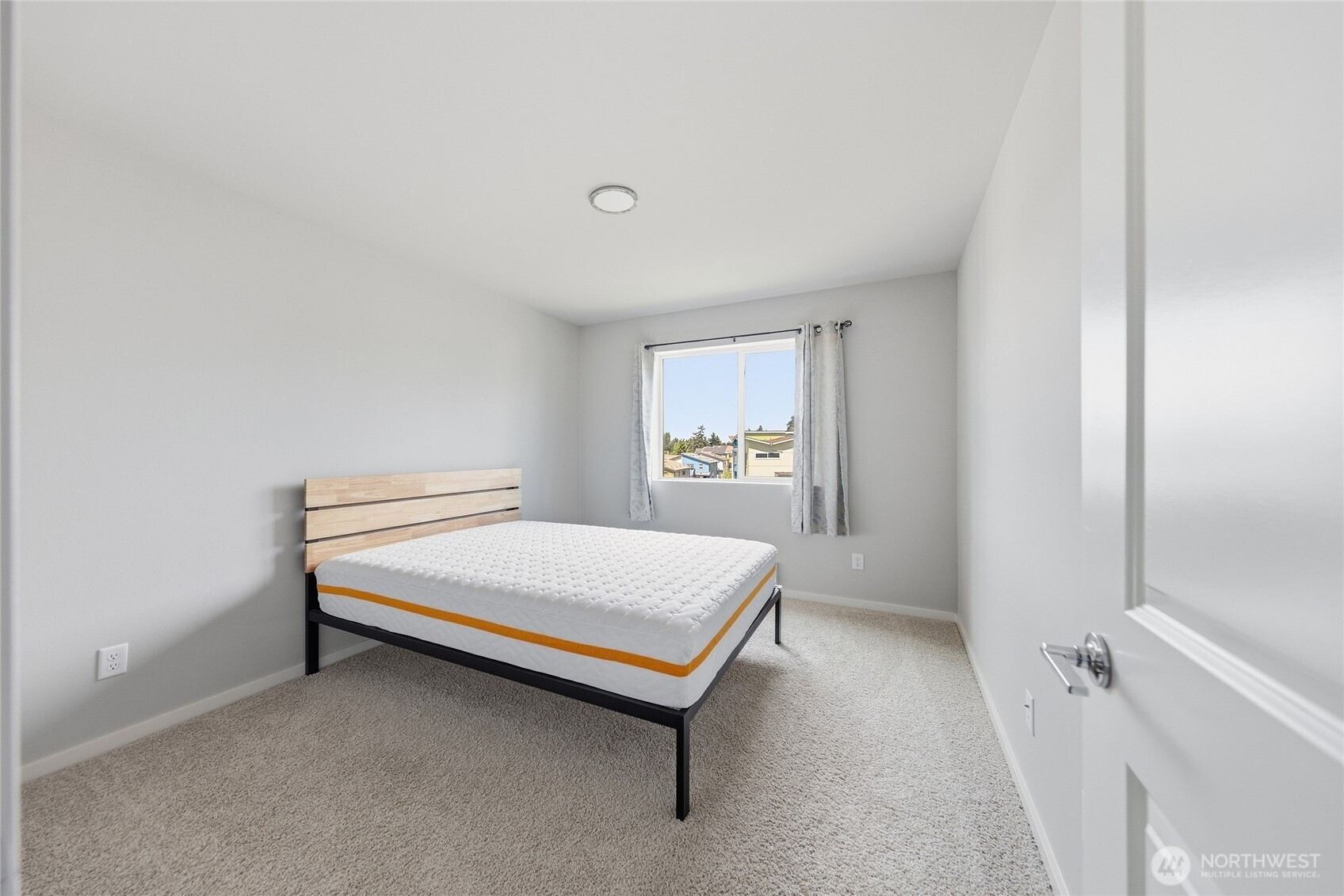1066 Southwest 99th Place, Unit 55 Seattle, WA 98106 - Photo 12 of 21 a bedroom with a bed and a window