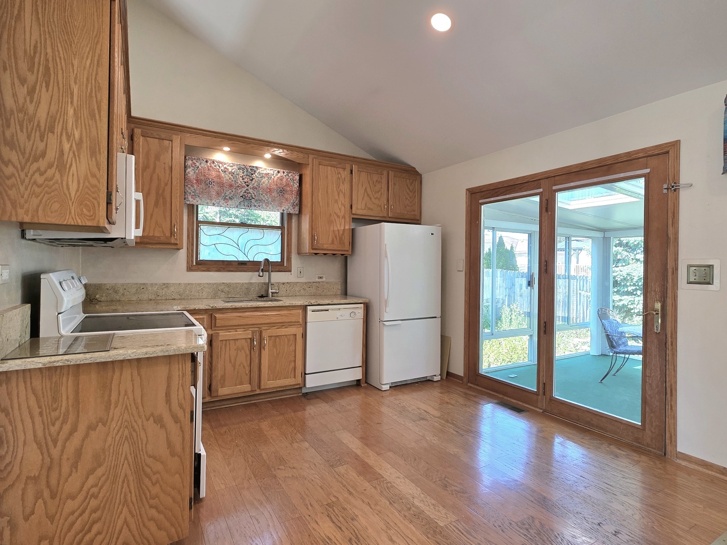 25028 Cashel Bay Road Manhattan, IL 60442 - Photo 6 of 32 a kitchen with a refrigerator sink and cabinets