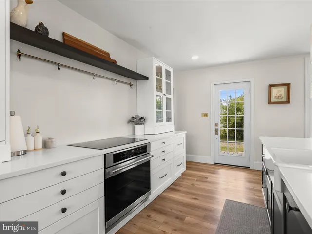a kitchen with a sink a counter top space and stainless steel appliances