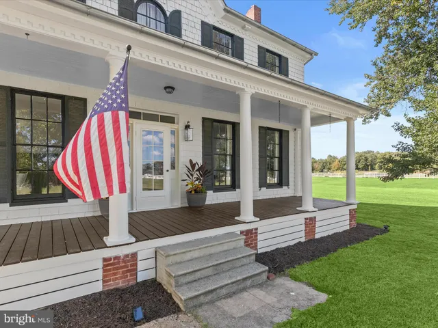 a front view of a house with garden and patio