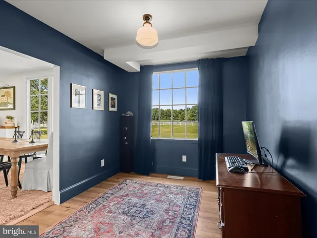a spacious bedroom with a bed and glass window