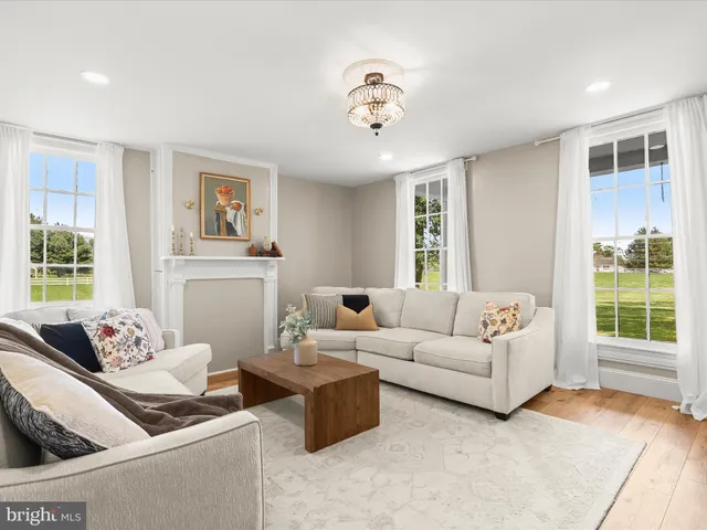 a living room with furniture and a chandelier