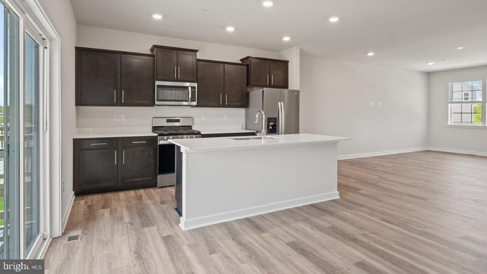 7521 Silver Thread Way Brandywine, MD 20613 - Photo 13 of 39 a kitchen with stainless steel appliances granite countertop a sink a stove a refrigerator and a microwave