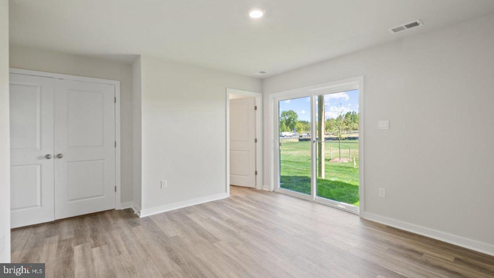 7521 Silver Thread Way Brandywine, MD 20613 - Photo 6 of 39 a view of an empty room with wooden floor and a window