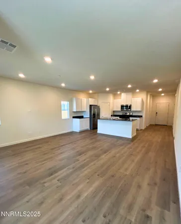 a view of an empty room with kitchen appliances