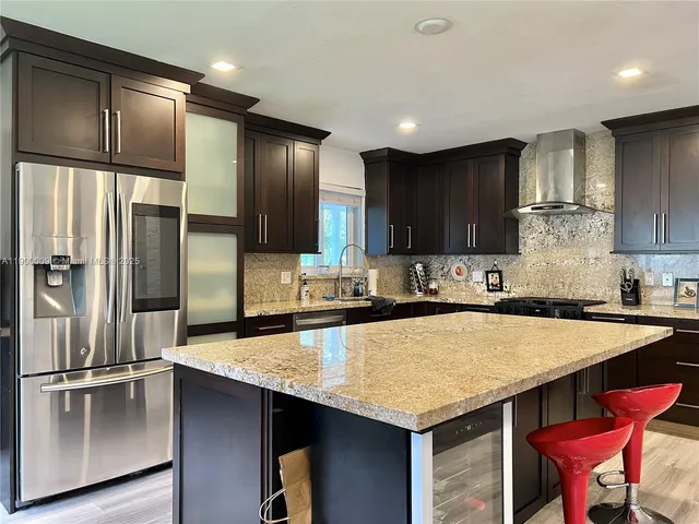 a kitchen with a stove and a wooden floor