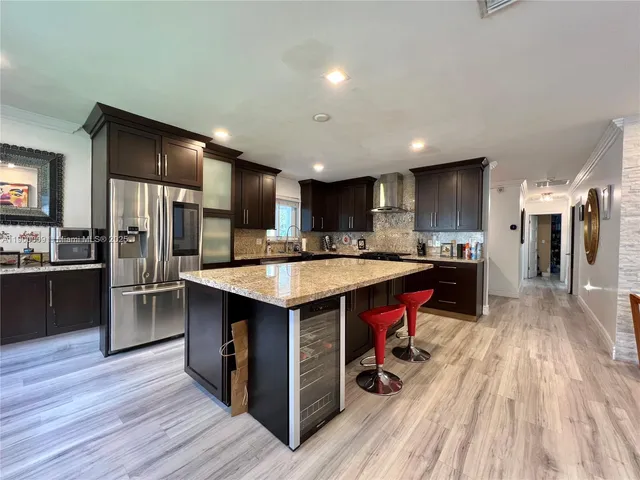 a kitchen with granite countertop a stove and cabinets