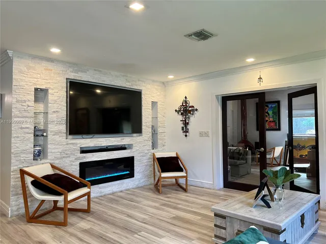 a kitchen with a sink cabinets and wooden floor