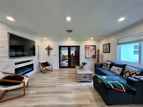 a dining room with furniture and a painting on the wall