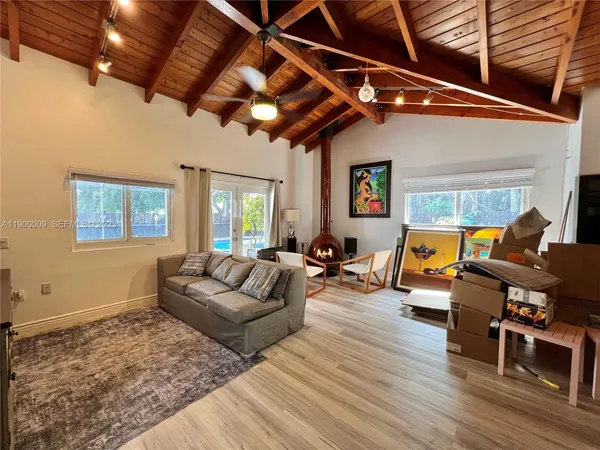 a living room with furniture or wooden floor and a large window