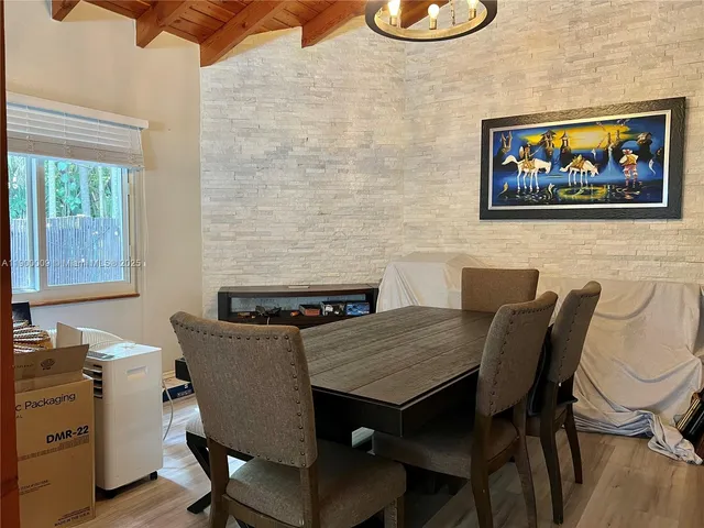 a white toilet sitting next to a bathroom sink and a mirror