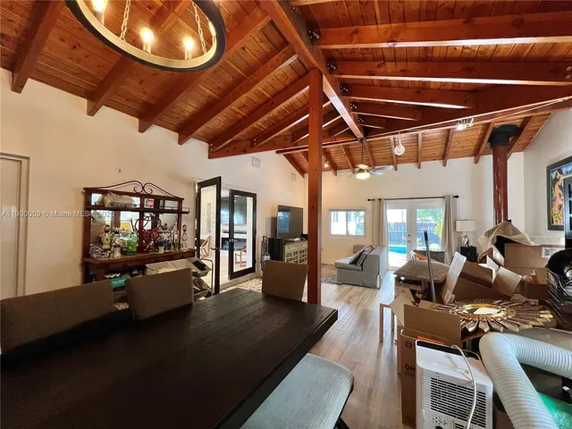 a living room with lots of furniture and a chandelier