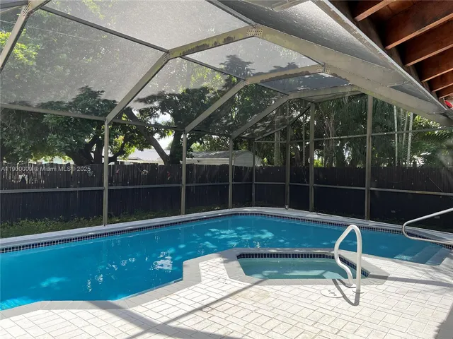 a house view with swimming pool in front of it