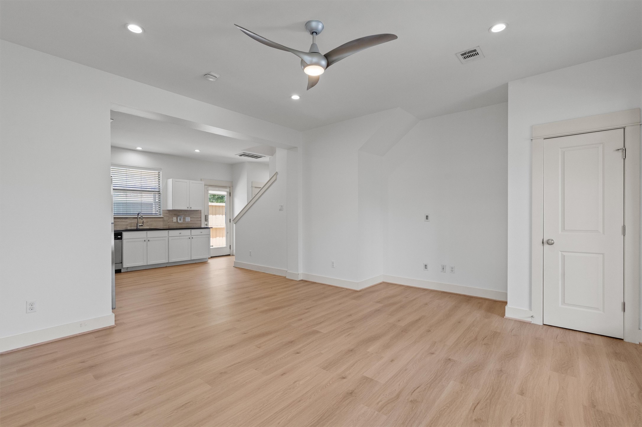 4120 Valley View Road, Unit A Austin, TX 78704 - Photo 5 of 29 an empty room with wooden floor a ceiling fan and windows