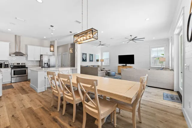 a kitchen with stainless steel appliances granite countertop white cabinets a stove a sink and dishwasher