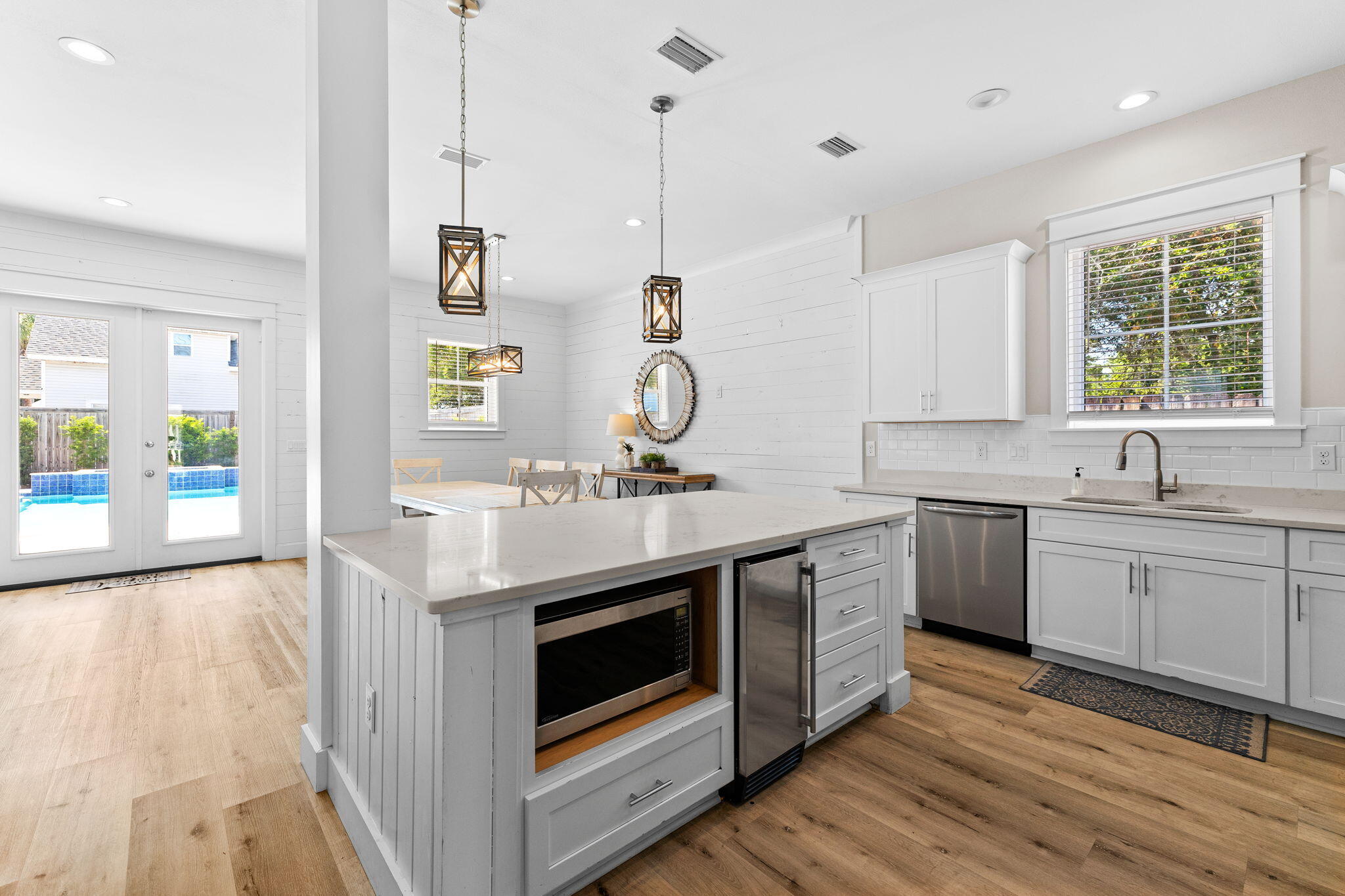 106 Shirah Street Destin, FL 32541 - Photo 17 of 91 a kitchen with stainless steel appliances granite countertop a sink stove and wooden floor