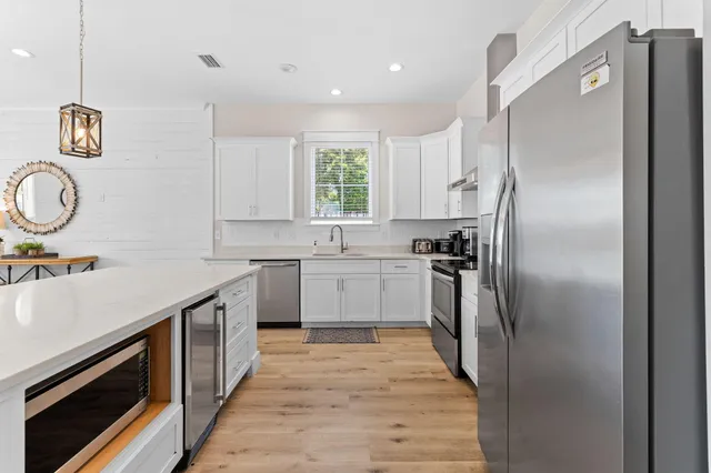a view of a livingroom with wooden floor and staircase