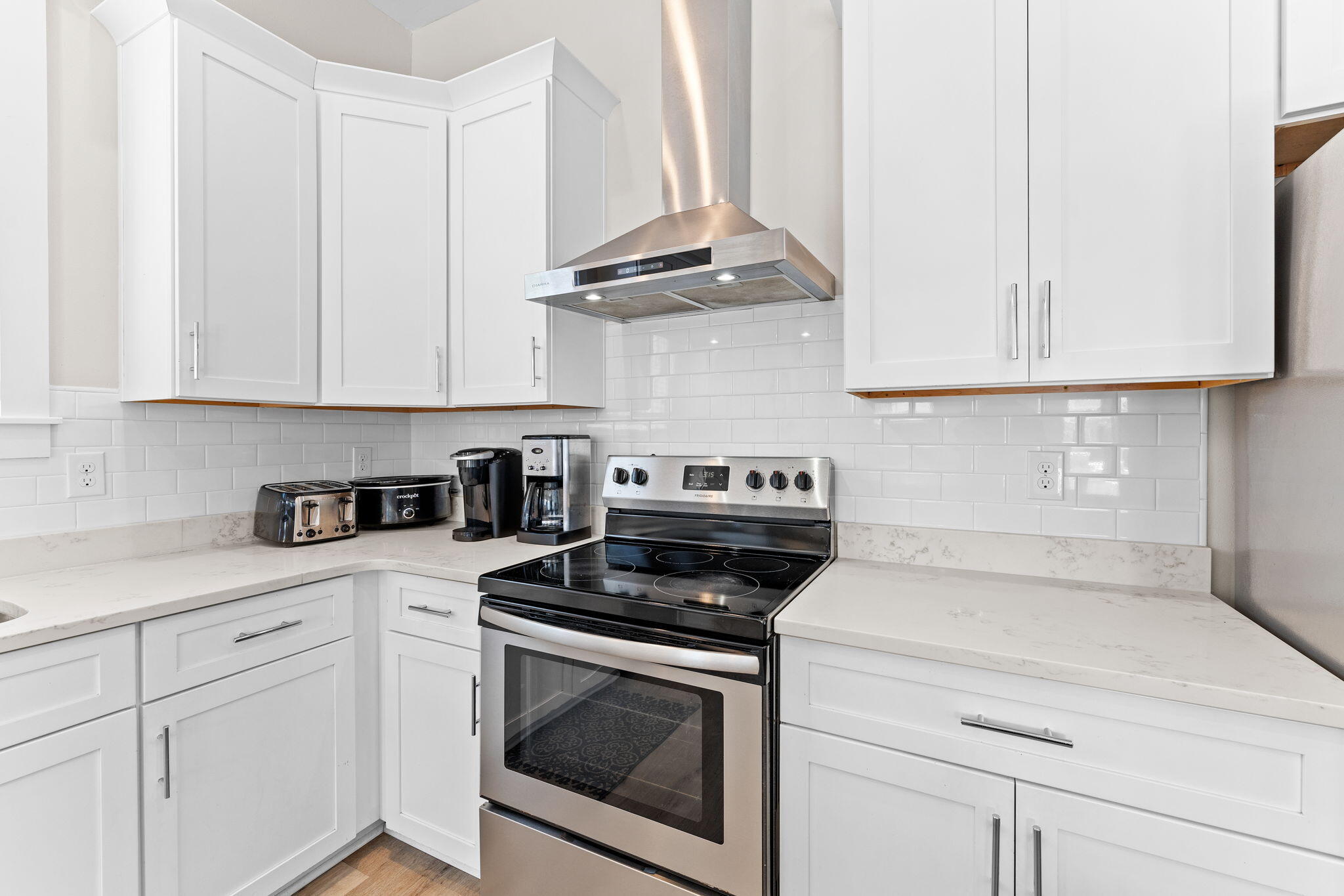 106 Shirah Street Destin, FL 32541 - Photo 19 of 91 a kitchen with stainless steel appliances granite countertop white cabinets a stove a sink and dishwasher